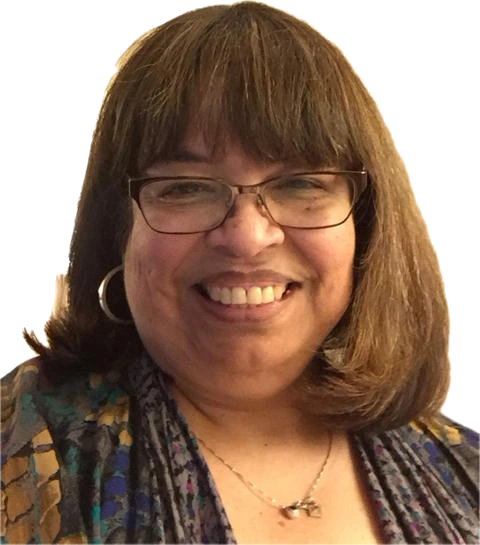 Smiling woman with glasses and brown hair.