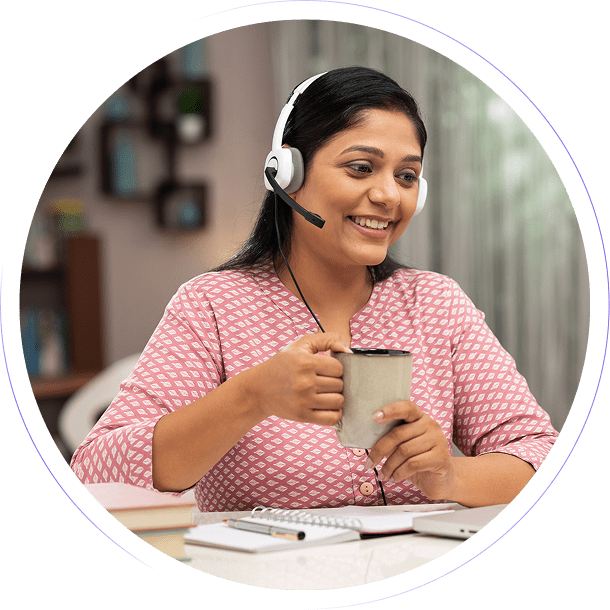 Woman with headset holding a coffee cup.
