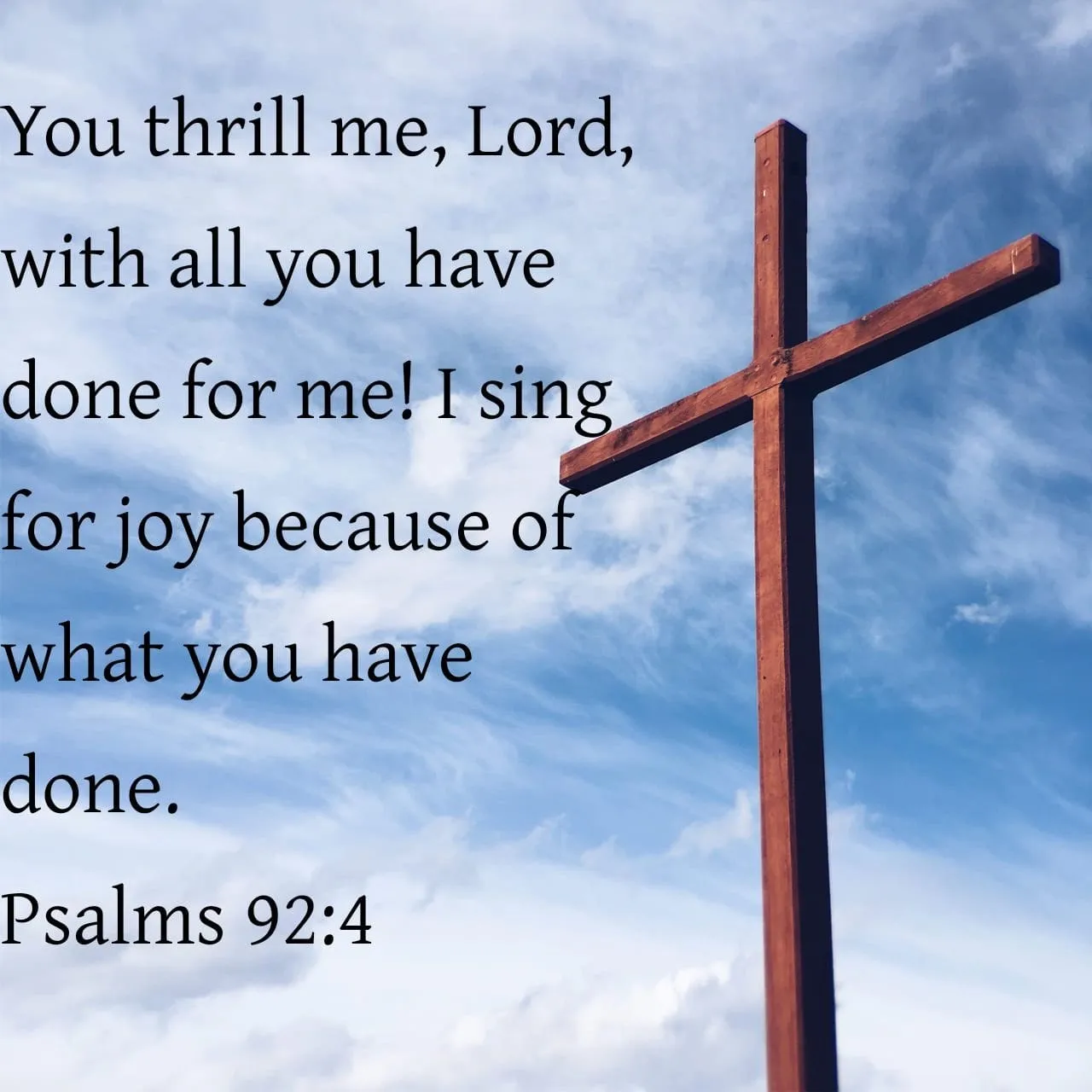 Wooden cross against a blue sky background.