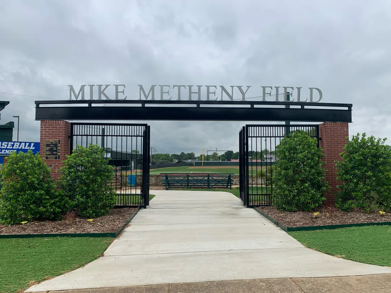 Entrance to Mike Metheny Field with greenery.